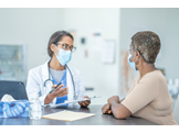 A genetic counselor speaking with a patient